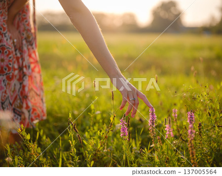 boho chic woman in a floral dress in European countryside 137005564