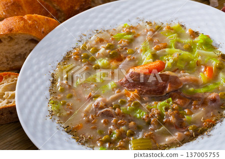 Scottish soup with lamb, root vegetables, pulses and barley 137005755