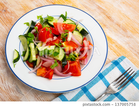 Fresh salad with cucumbers, tomatoes and onion 137005758