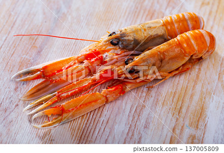 Raw Norway lobster on wooden table Raw Norway lobster on wooden table 137005809