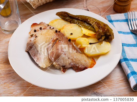 Tasty baked pork with potatoes and baked green pepper 137005830