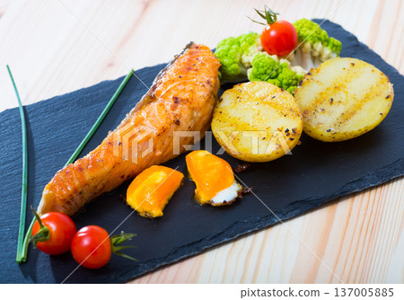 Roasted salmon and potatoes with egg yolk Roasted salmon and potatoes with egg yolk 137005885