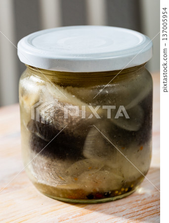 Closed jar with marinated herring fillets Closed jar with marinated herring fillets 137005954