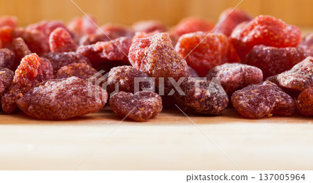 Tasty dried red strawberry berries on wooden surface Tasty dried red strawberry berries on wooden surface 137005964