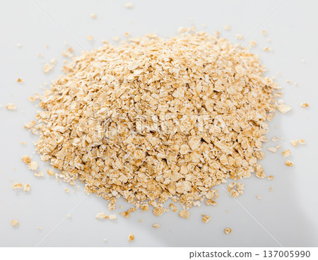 Handful of dry oatmeal on white background, nobody 137005990