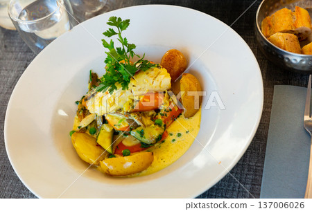 Hake fillet with vegetables and potatoes. French dish 137006026
