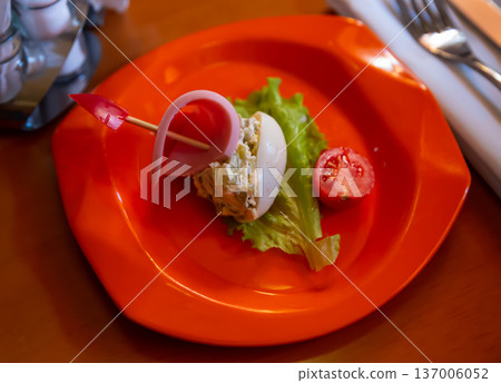 Salad for children from stuffed egg with sausage and vegetables Salad for children from stuffed egg with sausage and vegetables 137006052