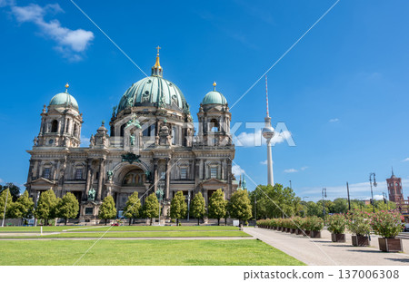 Berlin, germany, august 15, 2023. Berlin cathedral and the fernsehturm standing tall against a vibrant blue sky, highlighting german architecture and travel destinations Berlin, germany, august 15, 2023. Berlin cathedral and the fernsehturm standing tall against a vibrant blue sky, highlighting german architecture and travel destinations 137006308