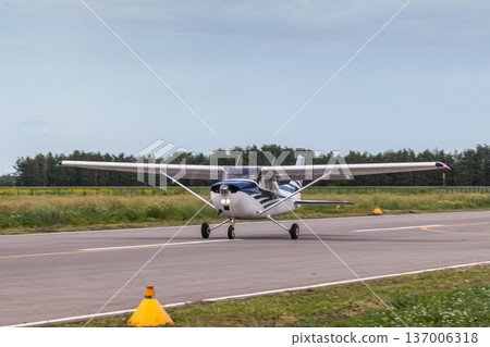Private single-engined piston-powered aircraft running on the runway 137006318