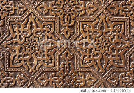Old carved wooden panel featuring Islamic patterns Old carved wooden panel featuring Islamic patterns 137006503
