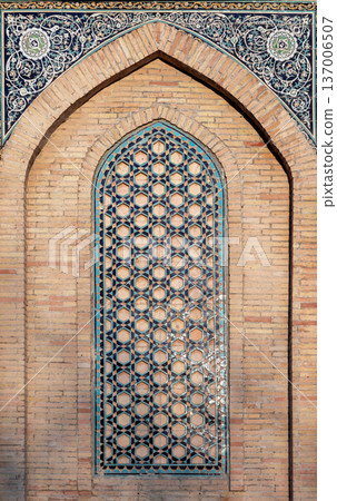 Arched geometric tile window of an ancient Mosque 137006507