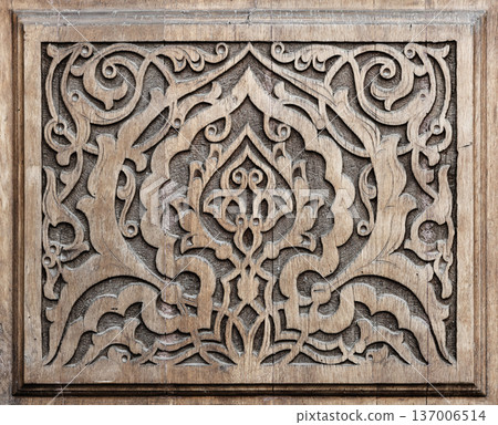 Carved wooden panel featuring intricate floral motifs Carved wooden panel featuring intricate floral motifs 137006514
