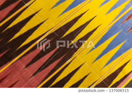 Vibrant ikat fabric featuring jagged stripes Vibrant ikat fabric featuring jagged stripes 137006515