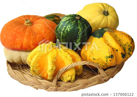 Assorted gourds and squash in a wicker basket symbolizing autumn harvest Assorted gourds and squash in a wicker basket symbolizing autumn harvest 137008122