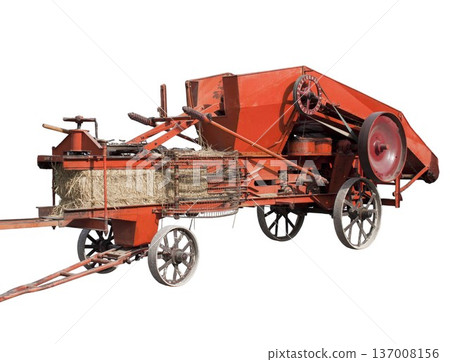 Vintage agricultural machine producing hay bales farming concept Vintage agricultural machine producing hay bales farming concept 137008156