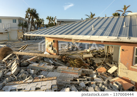 Ruined buildings in need of demolition or repair. Storm surge water and wind damaged houses roof and collapsed walls after hurricane in Florida Ruined buildings in need of demolition or repair. Storm surge water and wind damaged houses roof and collapsed walls after hurricane in Florida 137008444