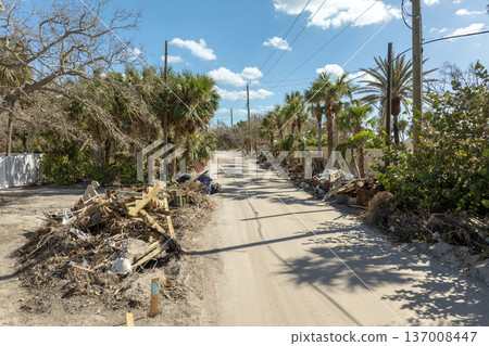 Piles of debris on street side after hurricane Milton on Manasota key road in Florida. Trash from severely damaged houses after storm surge. Consequences of natural disaster Piles of debris on street side after hurricane Milton on Manasota key road in Florida. Trash from severely damaged houses after storm surge. Consequences of natural disaster 137008447