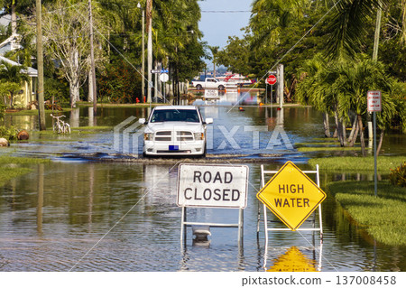 Road under water warning sign. City street closed because of flooding danger blocking driving of cars 137008458
