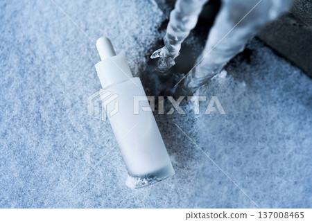 Skincare serum bottle on snow covered ice Skincare serum bottle on snow covered ice 137008465
