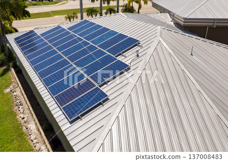 Solar roof covered with photovoltaic panels on private house for producing of clean ecological electricity in suburban rural area. Concept of investing in autonomous home for energy saving Solar roof covered with photovoltaic panels on private house for producing of clean ecological electricity in suburban rural area. Concept of investing in autonomous home for energy saving 137008483
