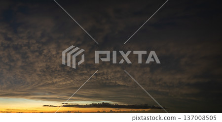 Dramatic sunset sky covered with colorful yellow clouds. Panoramic skyscape 137008505