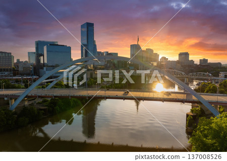 Downtown district highway bridge traffic in Nashville city, Tennessee at sunset. Brightly illuminated high skyscraper buildings in modern American midtown. 137008526