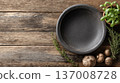 Rustic wooden kitchen background with black ceramic plate, fresh herbs and mushrooms, top view. 137008728