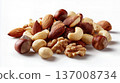 Assorted mixed nuts including almonds, cashews, hazelnuts, and walnuts isolated on white background. 137008734