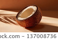 Half coconut with smooth white flesh on warm minimalist background, natural tropical food concept. 137008736