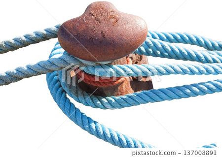 Rusted mooring bollard securing blue nautical rope 137008891