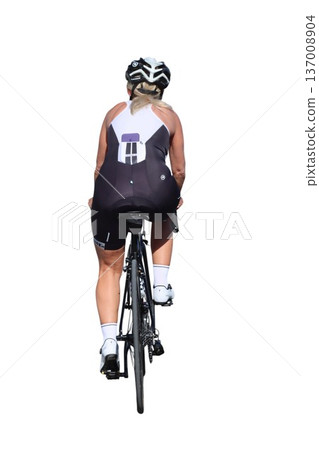 Female athlete training and cycling on a road bike 137008904