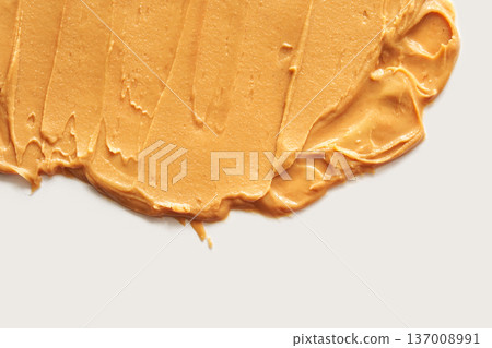 Smooth Creamy Peanut Butter Spread On White Surface With Visible Swirls And Textures Smooth Creamy Peanut Butter Spread On White Surface With Visible Swirls And Textures 137008991