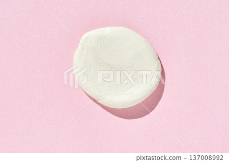 Flat white clay shape on pastel pink background casting soft shadow for artistic and creative 137008992