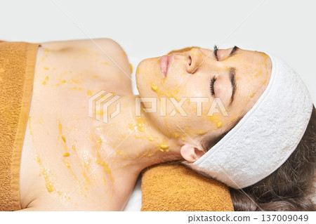 Young Caucasian Female Enjoying Relaxing Spa Treatment With Nourishing Facial Mask 137009049