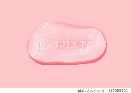 Close-up of transparent gel blob on pink background with textured surface and shimmering detail Close-up of transparent gel blob on pink background with textured surface and shimmering detail 137009201