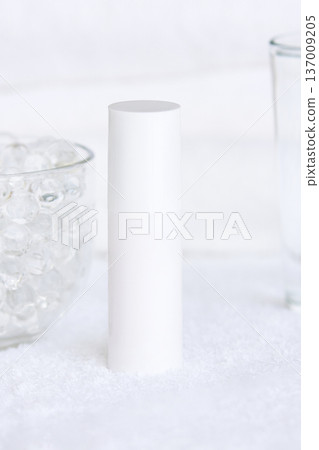 Minimalist white skincare bottle on soft textured surface for beauty and wellness concepts 137009205