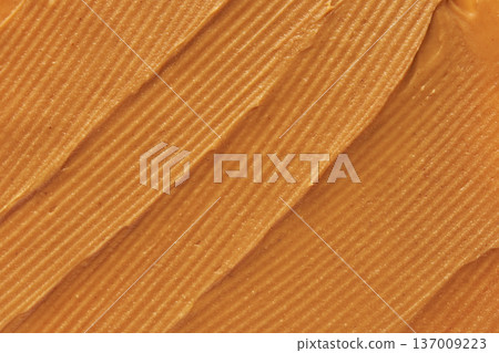 Smooth Peanut Butter Texture With Creamy Swirls In A Close-Up Edible Pattern Background Smooth Peanut Butter Texture With Creamy Swirls In A Close-Up Edible Pattern Background 137009223