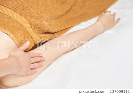 Asian Female Receiving Relaxing Arm Massage At Spa For Stress Relief And Wellness Asian Female Receiving Relaxing Arm Massage At Spa For Stress Relief And Wellness 137009311