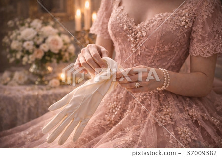 Close-up of Woman in Ornate Pink Gown Putting on Silk Gloves 137009382