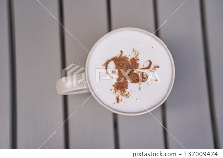 Top view of cappuccino with artistic cocoa butterfly on foam in ceramic mug on wooden table Top view of cappuccino with artistic cocoa butterfly on foam in ceramic mug on wooden table 137009474