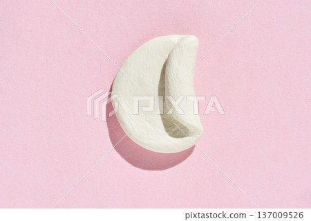 Minimalist white fortune cookie on pink background symbolizing luck, simplicity, and future Minimalist white fortune cookie on pink background symbolizing luck, simplicity, and future 137009526