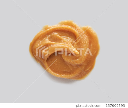 Creamy Peanut Butter Swirl On Gray Background - Smooth Texture And Delicious Nutty Spread Close-Up Creamy Peanut Butter Swirl On Gray Background - Smooth Texture And Delicious Nutty Spread Close-Up 137009593