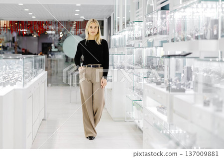Elegant woman choosing jewelry in a luxury store Elegant woman choosing jewelry in a luxury store 137009881