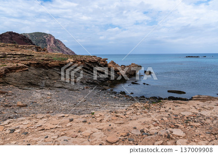 Scenic coastal landscape in Menorca with dramatic rock formations and the sea. Scenic coastal landscape in Menorca with dramatic rock formations and the sea. 137009908