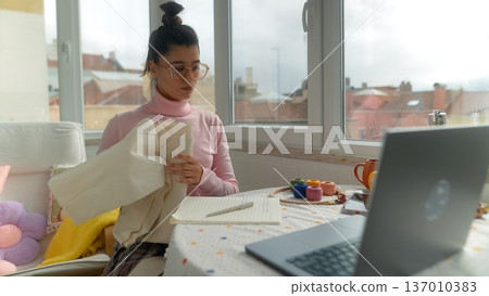 Bright morning scene with woman working and drinking coffee 137010383