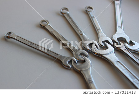 Mechanical connection of hex head spanners on white surface. Illustrative photography on the theme of support and cooperation 137011418