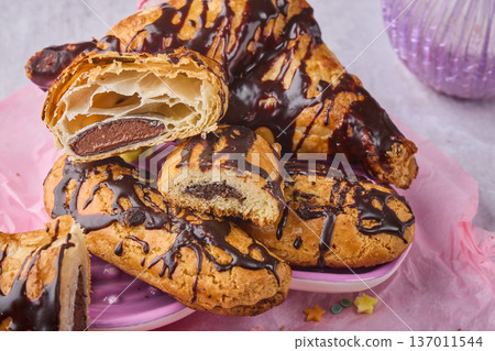Chocolate Drizzled Pastries with Cream Filling Chocolate Drizzled Pastries with Cream Filling 137011544