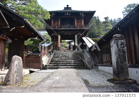 Old townscape of Takayama city, Gifu prefecture, Japan. Retro temple on Higashiyama promenade. Deep Japanese wooden architecture and stone monuments. 137011573