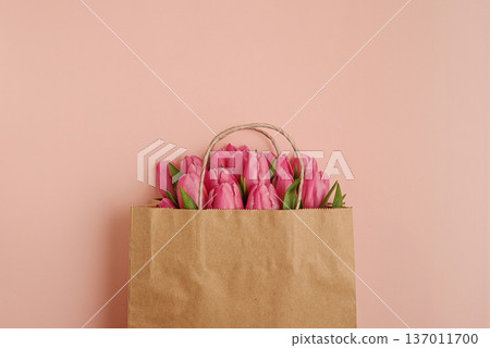 Gift Bag with Pink Tulips on Pink Background. Valentines or Mothers Day Celebration Gift Bag with Pink Tulips on Pink Background. Valentines or Mothers Day Celebration 137011700