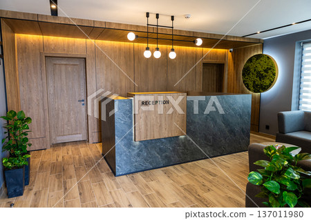 Modern hotel reception desk interior with stylish lobby design and warm lighting Modern hotel reception desk interior with stylish lobby design and warm lighting 137011980